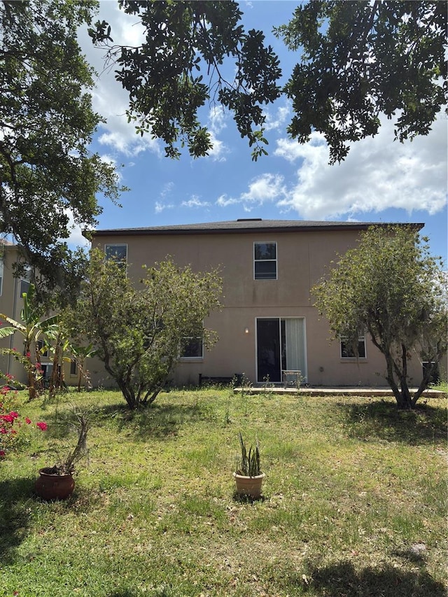 422 Janice Kay Pl, Kissimmee, FL 34744 - rear view of house with a yard and stucco siding