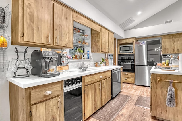 2475 Cox Rd, Cocoa, FL 32926 - kitchen featuring light wood-type flooring, stainless steel appliances, vaulted ceiling, and visible vents