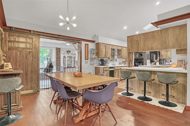 2475 Cox Rd, Cocoa, FL 32926 - dining area with light wood finished floors and a notable chandelier