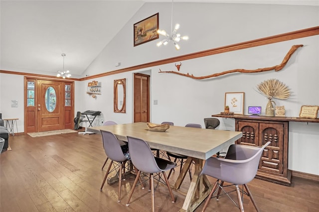 2475 Cox Rd, Cocoa, FL 32926 - dining area featuring baseboards, wood finished floors, an inviting chandelier, and high vaulted ceiling