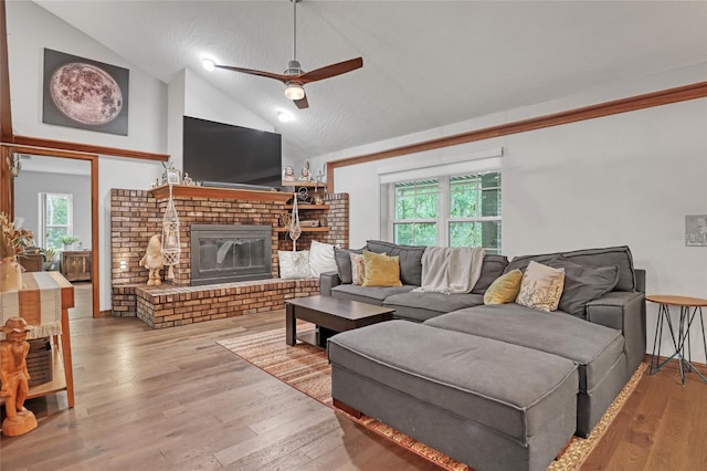 2475 Cox Rd, Cocoa, FL 32926 - living room featuring a brick fireplace, wood finished floors, a wealth of natural light, and ceiling fan