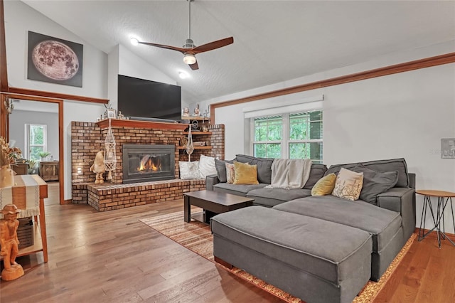 2475 Cox Rd, Cocoa, FL 32926 - living area featuring vaulted ceiling, a ceiling fan, a brick fireplace, and a wealth of natural light