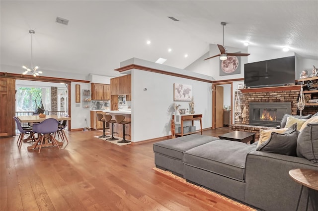 2475 Cox Rd, Cocoa, FL 32926 - living area with visible vents, a brick fireplace, high vaulted ceiling, and light wood-type flooring
