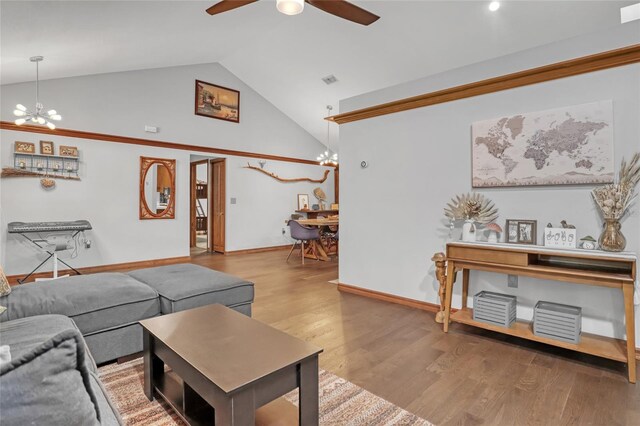 2475 Cox Rd, Cocoa, FL 32926 - living room featuring baseboards, visible vents, ceiling fan with notable chandelier, wood finished floors, and high vaulted ceiling