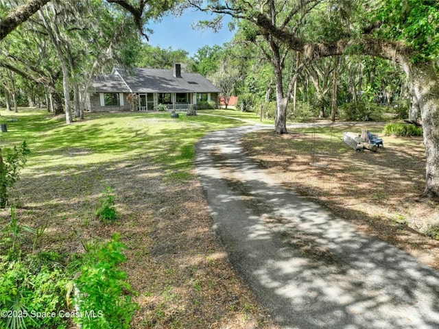 2475 Cox Rd, Cocoa, FL 32926 - view of front of property featuring a chimney, aphalt driveway, and a front yard