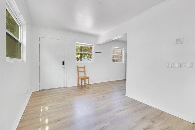 spare room with wood finished floors and baseboards