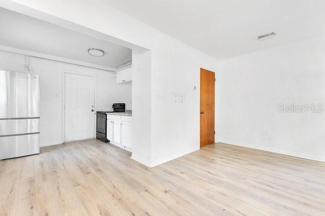 unfurnished living room featuring light wood-style floors and baseboards