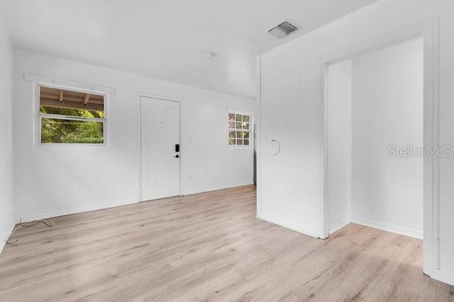 empty room with light wood finished floors