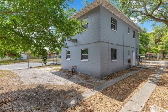 view of property exterior featuring fence