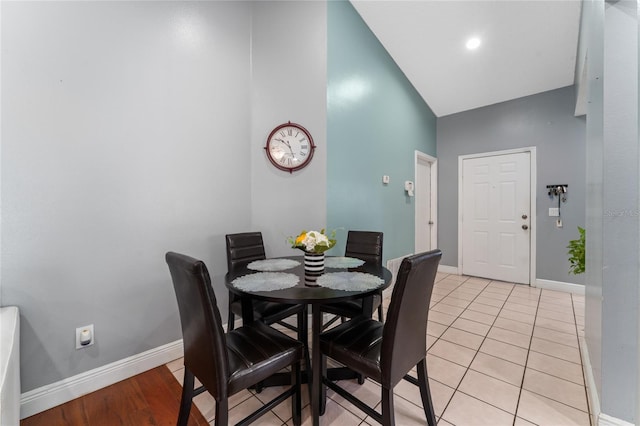 221 Indian Point Cir, Kissimmee, FL 34746 - dining room with baseboards, high vaulted ceiling, and light tile patterned flooring