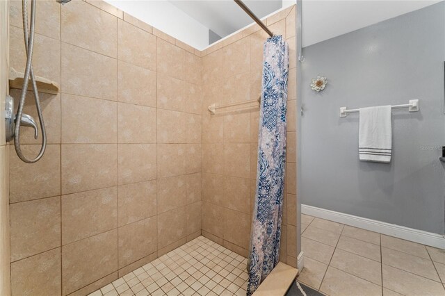 221 Indian Point Cir, Kissimmee, FL 34746 - full bathroom with tile patterned floors, baseboards, and a tile shower