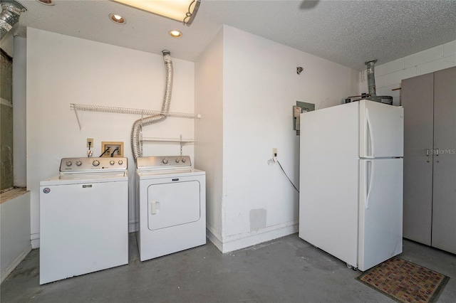 221 Indian Point Cir, Kissimmee, FL 34746 - washroom with baseboards, recessed lighting, washing machine and dryer, a textured ceiling, and laundry area