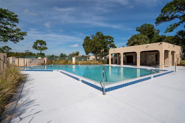 221 Indian Point Cir, Kissimmee, FL 34746 - pool featuring a patio and fence