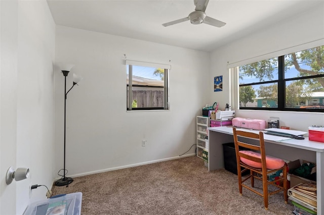 office area featuring carpet floors, ceiling fan, baseboards, and a wealth of natural light