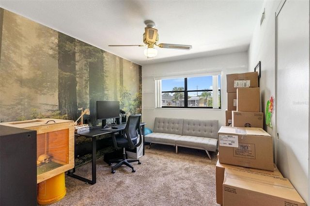 office space featuring a ceiling fan and carpet