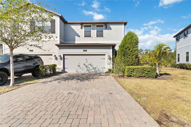 11150 Whistling Pine Way, Orlando, FL 32832 - view of front facade with a front yard, decorative driveway, and a garage