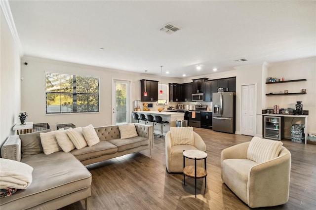 11150 Whistling Pine Way, Orlando, FL 32832 - living area featuring visible vents, crown molding, wood finished floors, wine cooler, and recessed lighting
