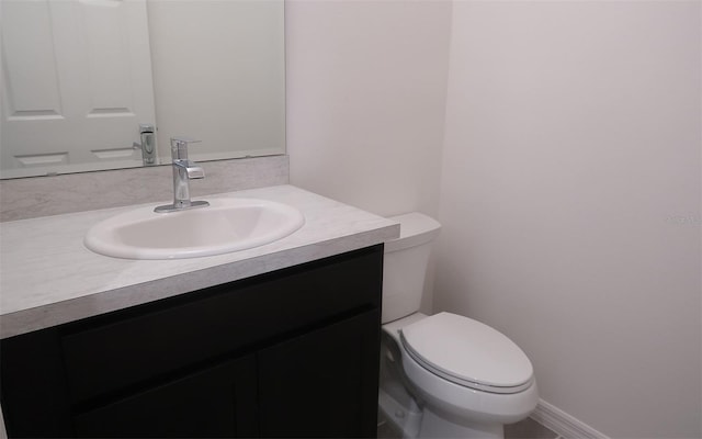 half bathroom featuring toilet and vanity