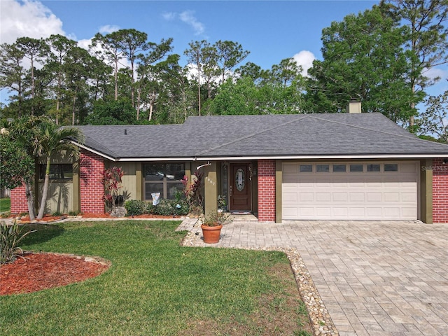 1007 Gammage Pt, Oviedo, FL 32765 - ranch-style house featuring brick siding, an attached garage, decorative driveway, a front lawn, and a chimney