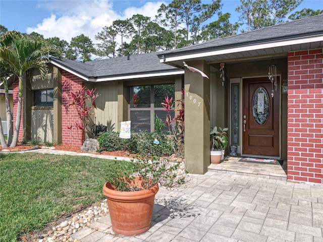 1007 Gammage Pt, Oviedo, FL 32765 - view of exterior entry featuring brick siding and a lawn