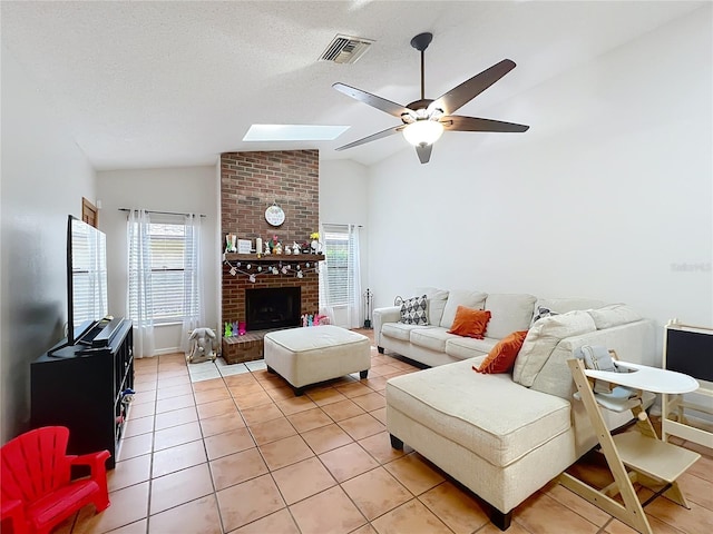 1007 Gammage Pt, Oviedo, FL 32765 - living area with lofted ceiling, a ceiling fan, light tile patterned floors, a brick fireplace, and a skylight