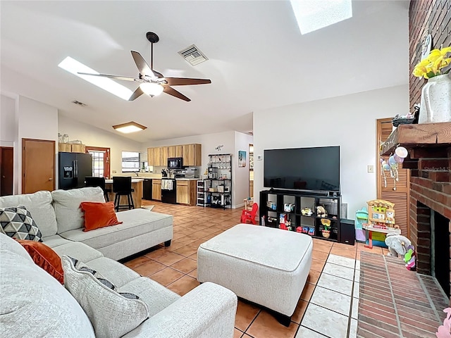1007 Gammage Pt, Oviedo, FL 32765 - living room featuring light tile patterned floors, a skylight, lofted ceiling, a ceiling fan, and a fireplace