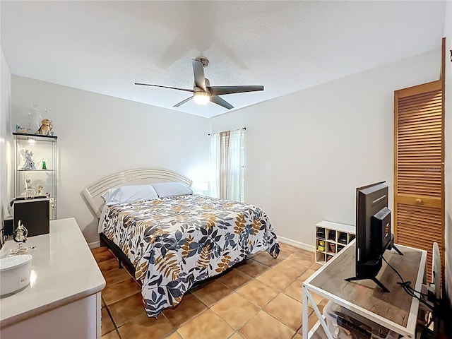 1007 Gammage Pt, Oviedo, FL 32765 - bedroom featuring light tile patterned flooring, a ceiling fan, a closet, and baseboards