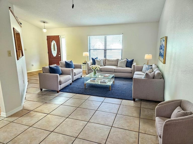 1007 Gammage Pt, Oviedo, FL 32765 - living area featuring light tile patterned floors, a textured ceiling, and baseboards