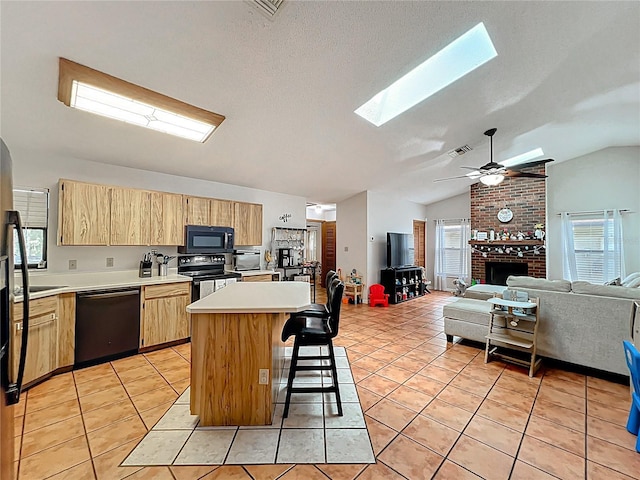 1007 Gammage Pt, Oviedo, FL 32765 - kitchen featuring black appliances, light brown cabinetry, light countertops, vaulted ceiling, and open floor plan