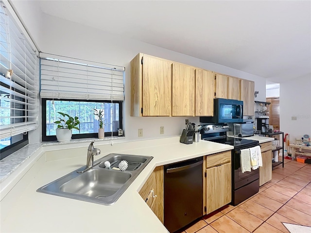 1007 Gammage Pt, Oviedo, FL 32765 - kitchen with black appliances, light brown cabinets, a sink, light tile patterned flooring, and light countertops