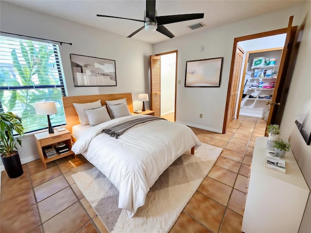 1007 Gammage Pt, Oviedo, FL 32765 - bedroom with light tile patterned floors, baseboards, and a ceiling fan