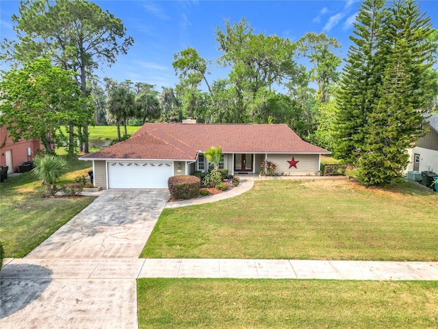 4423 Real Ct, Orlando, FL 32808 - single story home featuring a front yard, a chimney, concrete driveway, and an attached garage