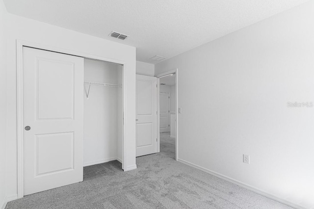 172 River Front Way, Edgewater, FL 32141 - unfurnished bedroom featuring a closet, baseboards, carpet flooring, and visible vents