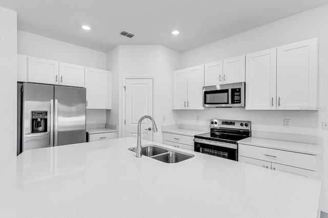 172 River Front Way, Edgewater, FL 32141 - kitchen with visible vents, a sink, light countertops, stainless steel appliances, and white cabinetry