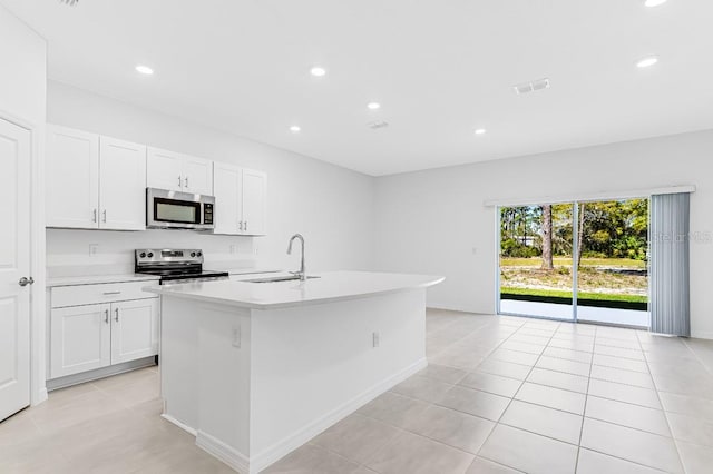 172 River Front Way, Edgewater, FL 32141 - kitchen featuring white cabinets, a sink, light countertops, an island with sink, and stainless steel appliances