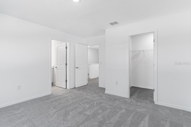 172 River Front Way, Edgewater, FL 32141 - unfurnished bedroom with a spacious closet, carpet flooring, a textured ceiling, and visible vents