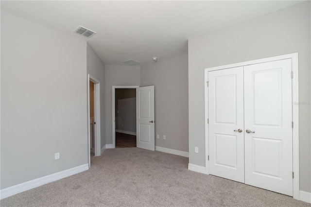 12950 SW 38th Cir, Ocala, FL 34473 - unfurnished bedroom with baseboards, visible vents, a closet, and carpet flooring