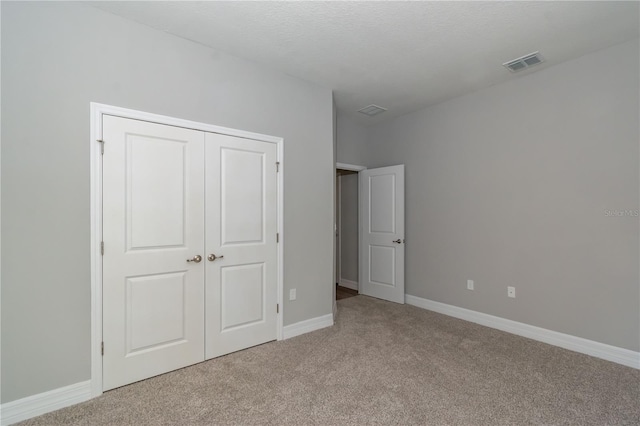 12950 SW 38th Cir, Ocala, FL 34473 - unfurnished bedroom with carpet floors, a closet, baseboards, and visible vents