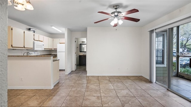 5962 Westgate Dr Unit 101, Orlando, FL 32835 - kitchen featuring light tile patterned flooring, a ceiling fan, baseboards, white appliances, and white cabinets