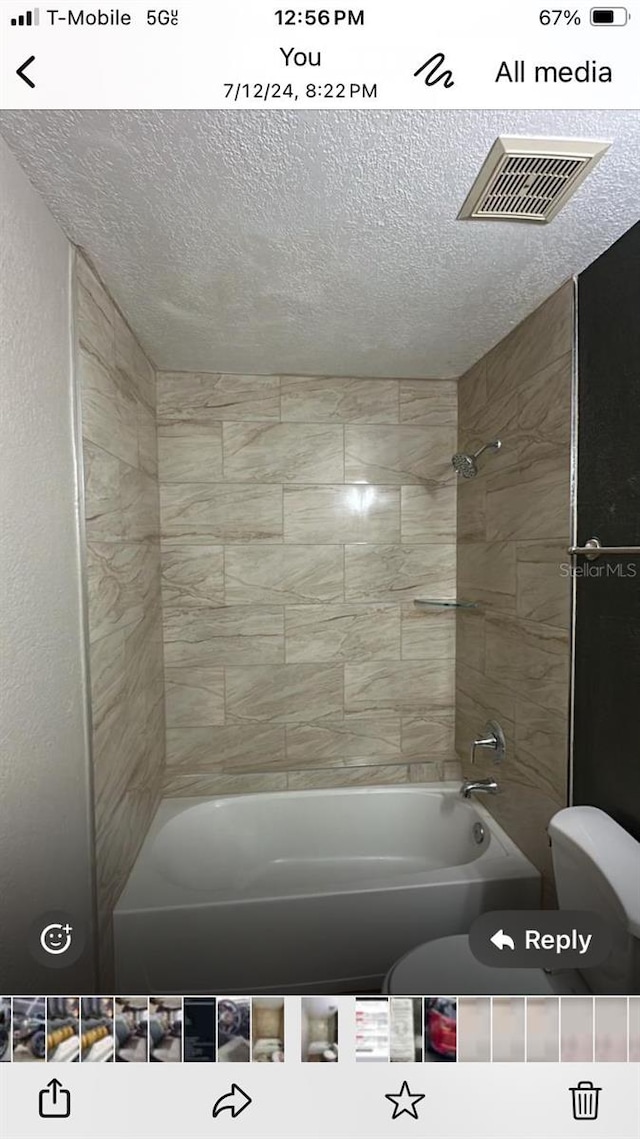 5962 Westgate Dr Unit 101, Orlando, FL 32835 - bathroom with shower / bathing tub combination, toilet, and a textured ceiling