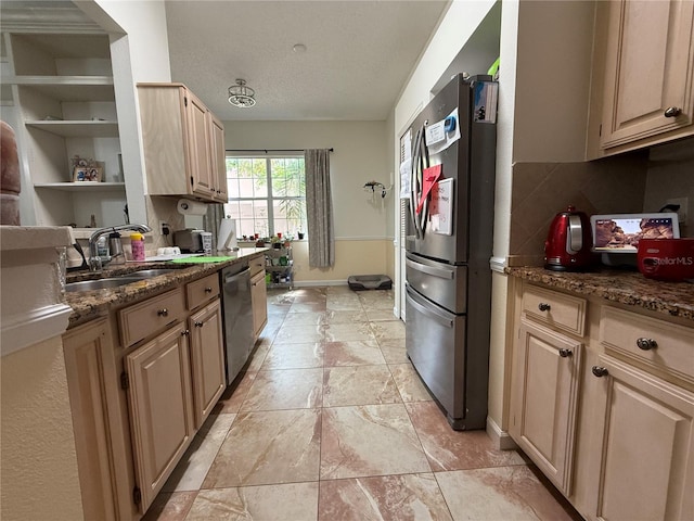 14326 Mandolin Dr, Orlando, FL 32837 - kitchen with light brown cabinets, a textured ceiling, backsplash, appliances with stainless steel finishes, and a sink