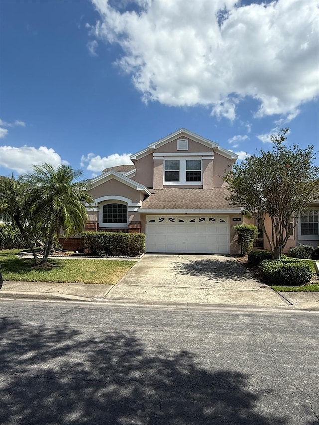 14326 Mandolin Dr, Orlando, FL 32837 - traditional-style house with driveway, stucco siding, and a garage