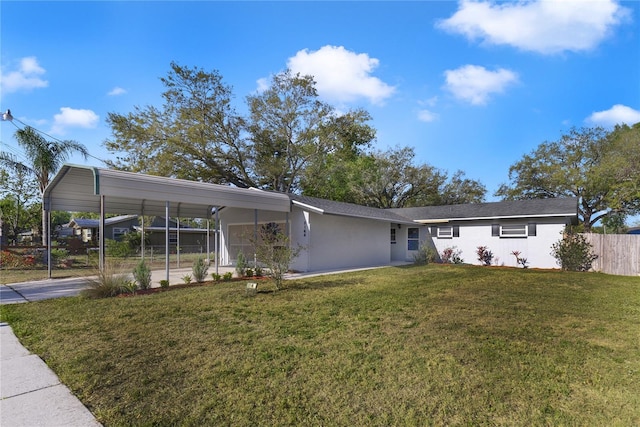 5144 Orange Ave, Winter Park, FL 32792 - view of front of house with fence, concrete driveway, stucco siding, a front yard, and a carport