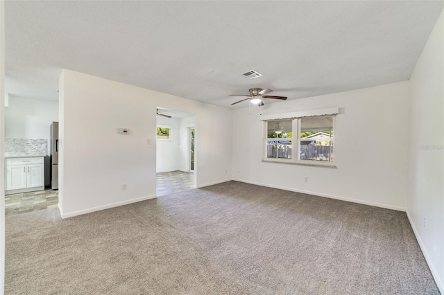 5144 Orange Ave, Winter Park, FL 32792 - carpeted empty room featuring a ceiling fan, plenty of natural light, and baseboards