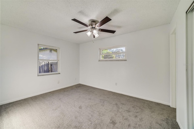 5144 Orange Ave, Winter Park, FL 32792 - empty room with a textured ceiling, carpet, baseboards, and a ceiling fan