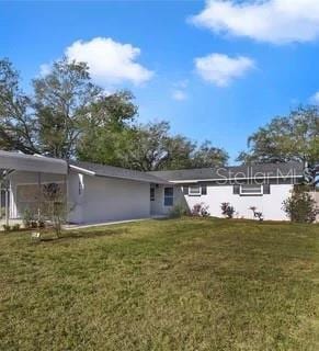 5144 Orange Ave, Winter Park, FL 32792 - back of property featuring a yard and a carport