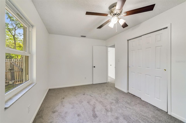 5144 Orange Ave, Winter Park, FL 32792 - unfurnished bedroom featuring carpet flooring, baseboards, a closet, a ceiling fan, and a textured ceiling