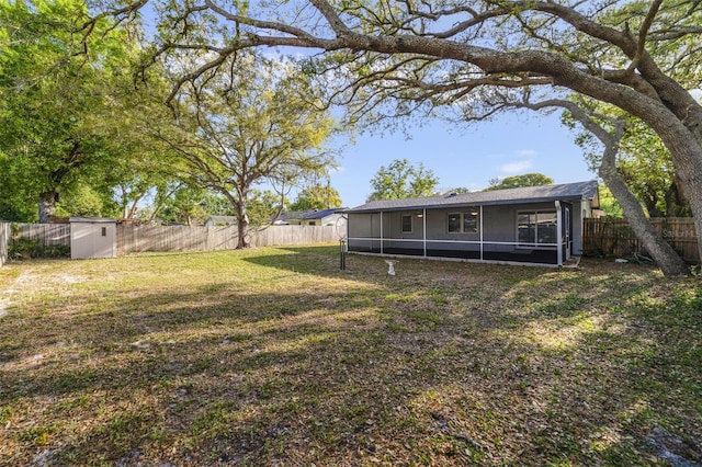 5144 Orange Ave, Winter Park, FL 32792 - view of yard featuring an outbuilding, a sunroom, a storage shed, and a fenced backyard