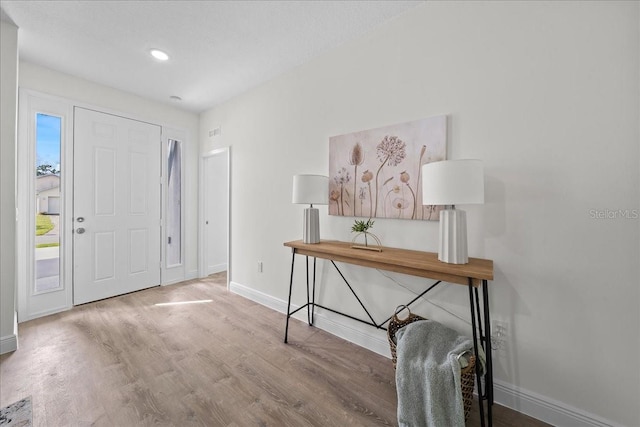 entrance foyer with wood finished floors and baseboards
