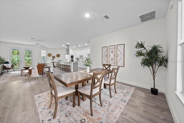dining space with recessed lighting, light wood-style floors, and visible vents